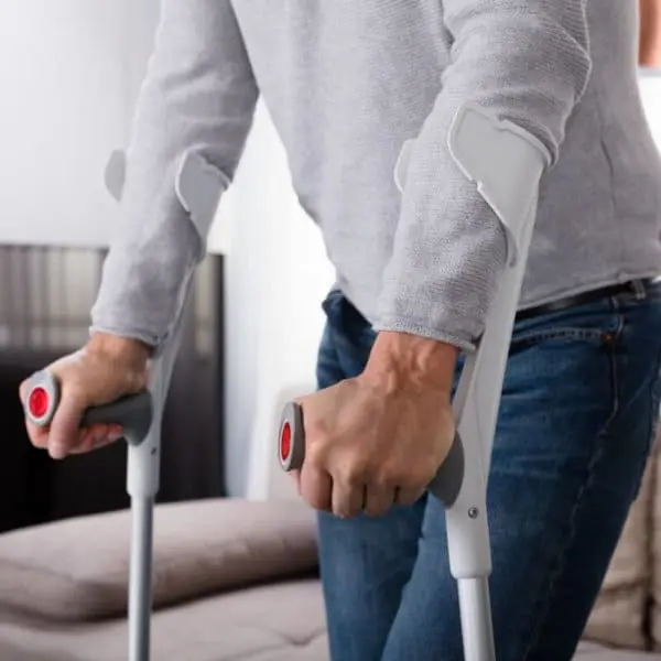 A man walking with crutches