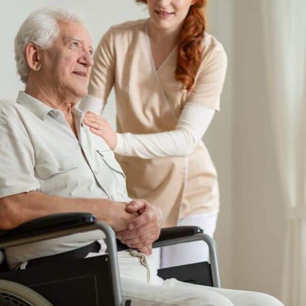 senior_in_wheelchair_with_caregiver.jpeg