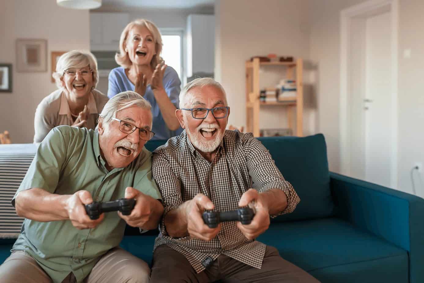 seniors playing play station in the celebrant's house, one of the best 75th birthday ideas