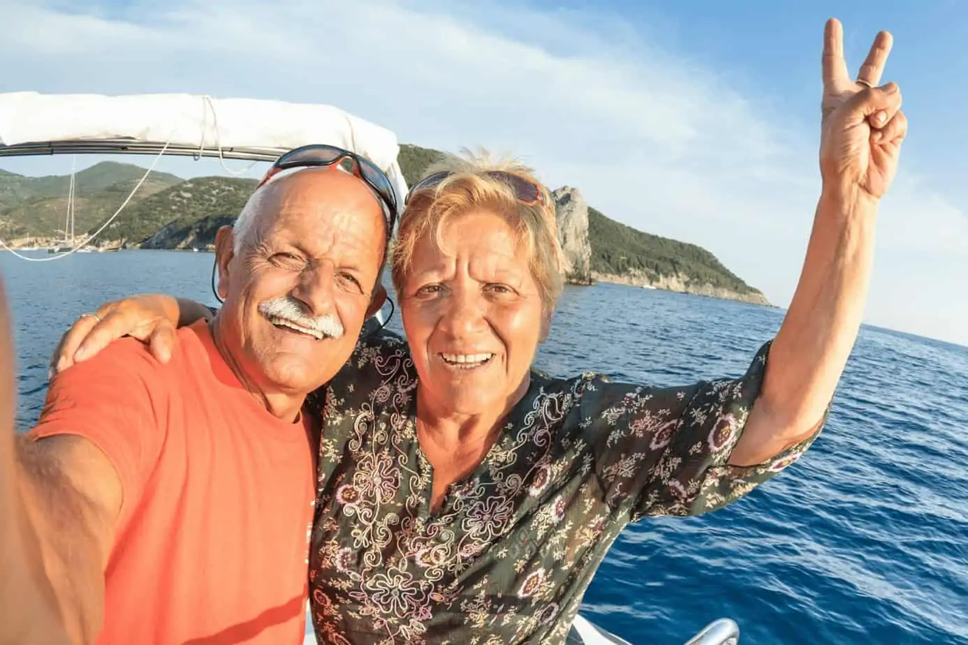 a selfie photo of a senior couple while riding a boat