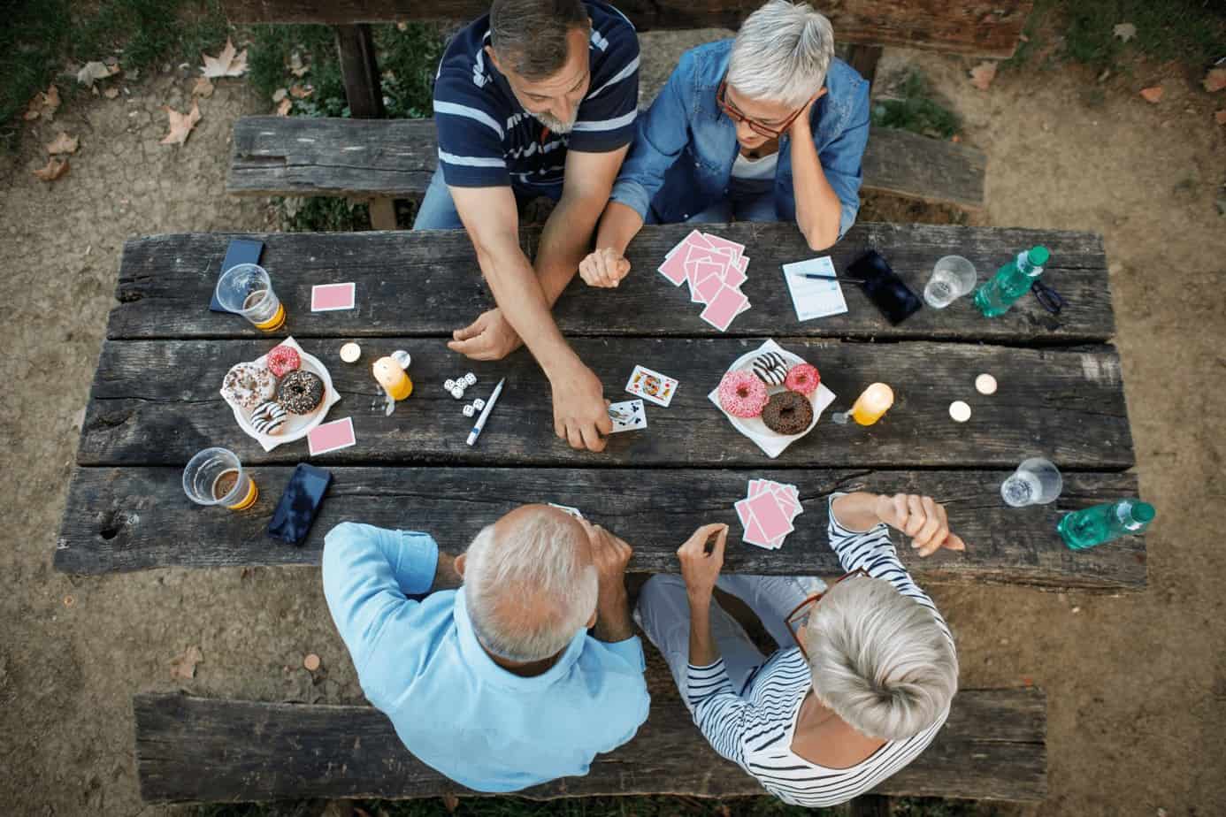 group of senior citizens playing cards