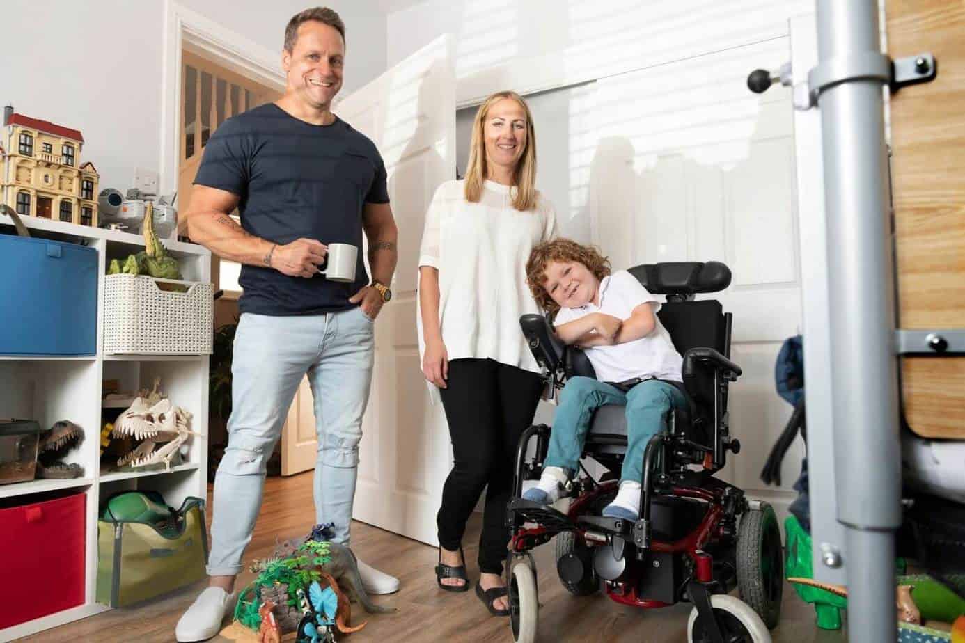 mother and father with his son in a power wheelchair