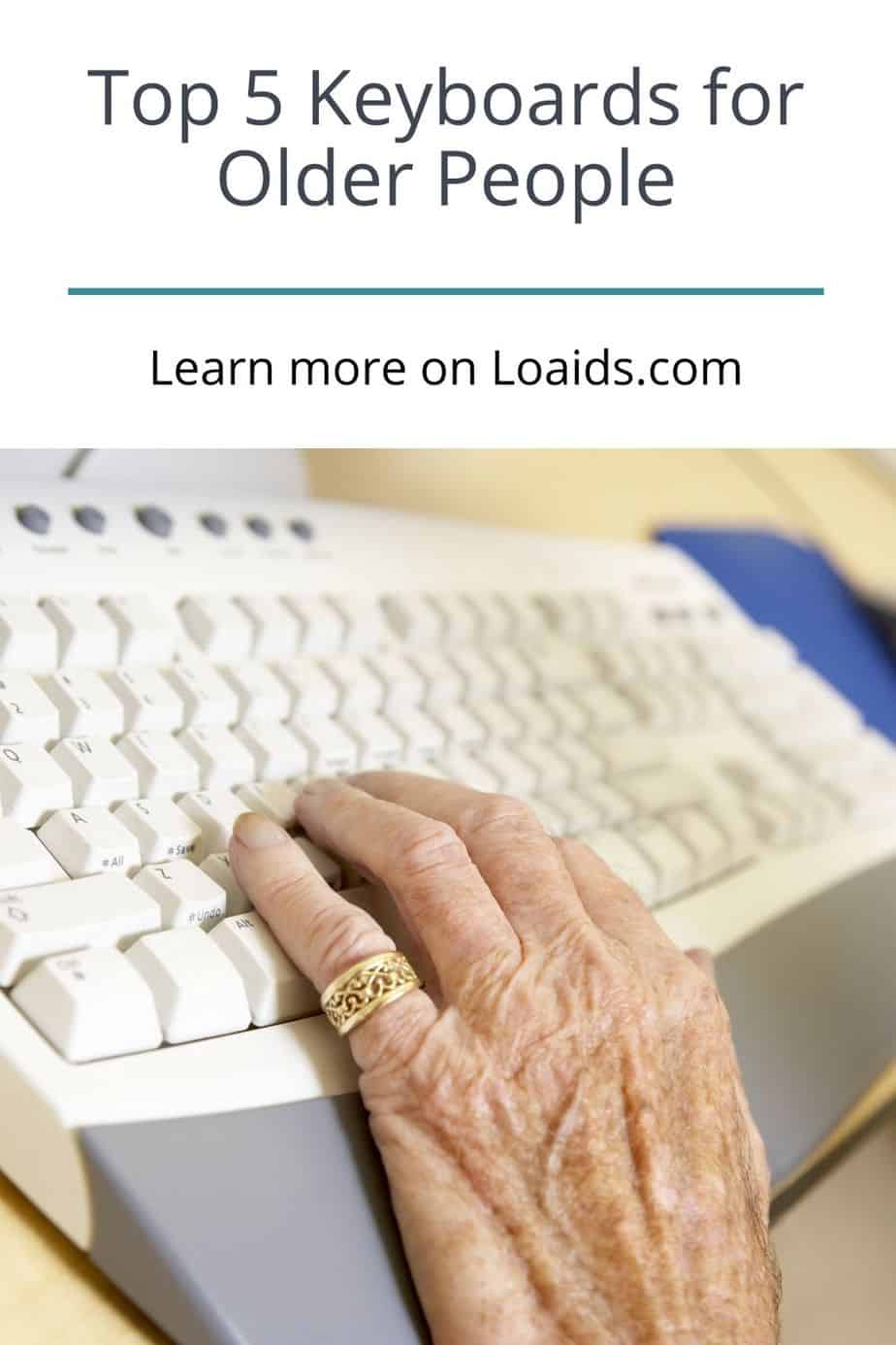 a hand of a senior lady using a white keyboard