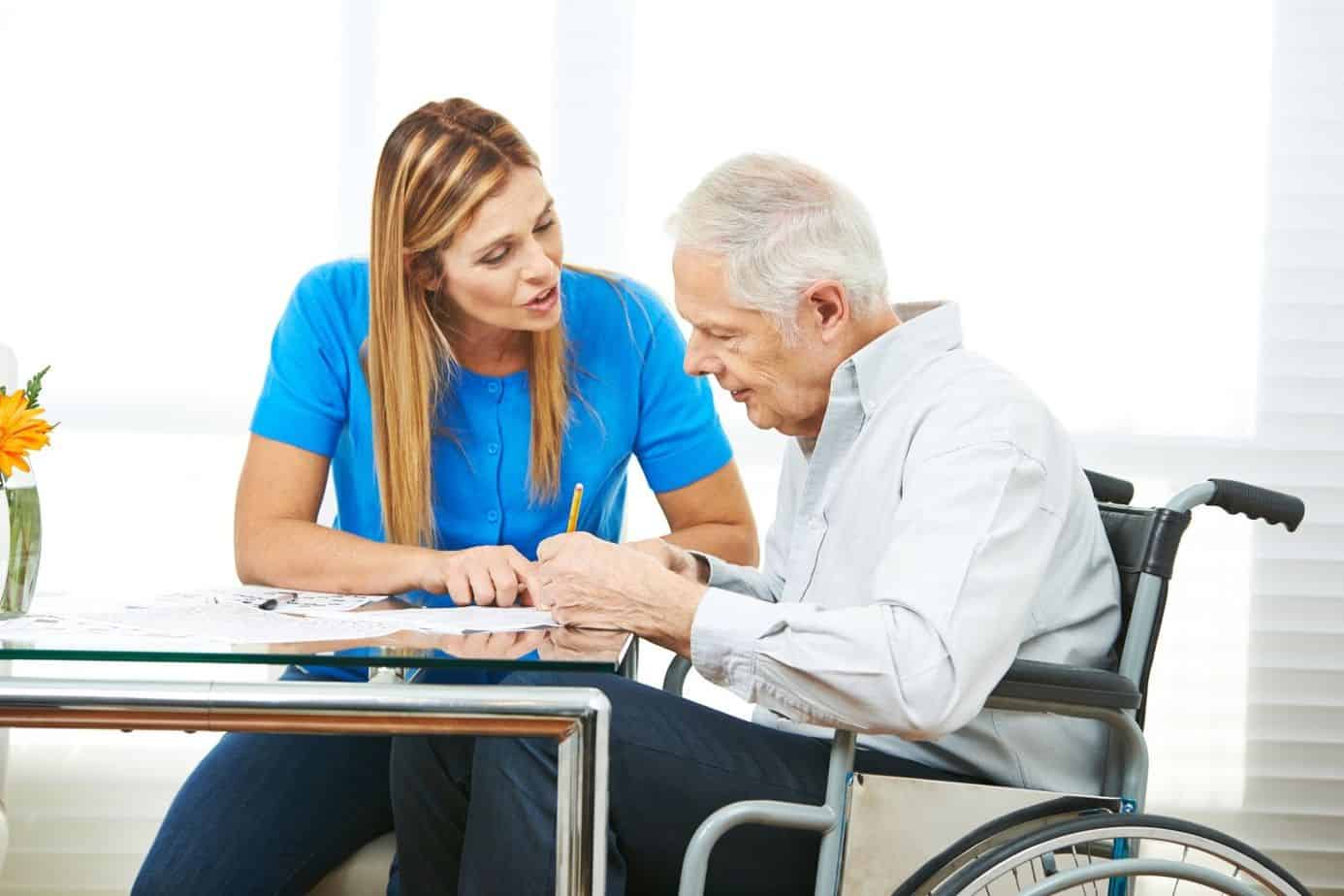 senior man writing an application for a free wheelchair