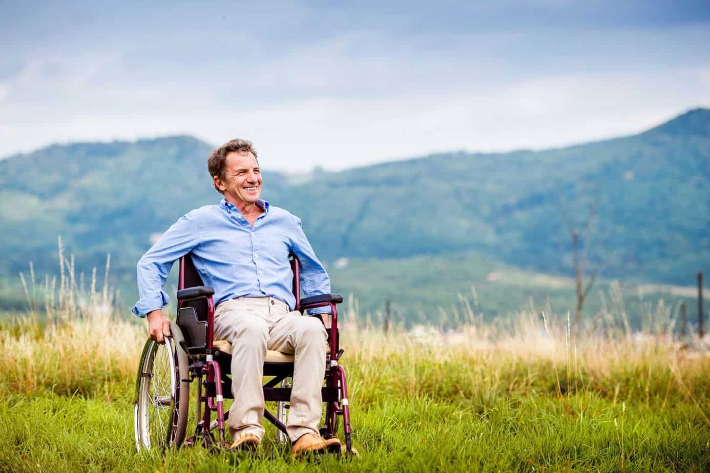 man happily riding a free wheelchair after discovering the answer to "How can I get a wheelchair for free?"