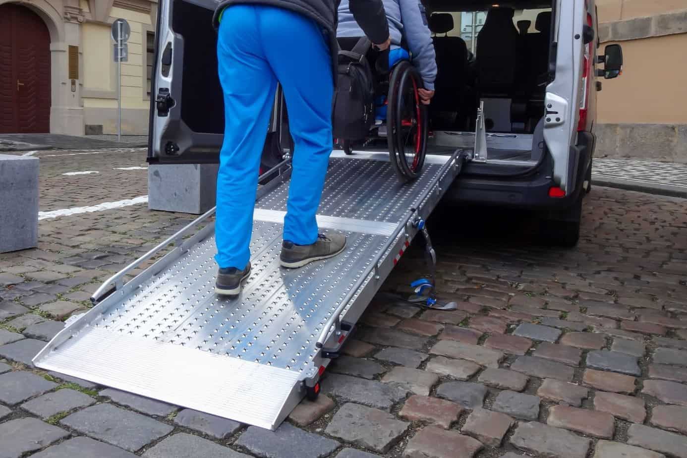 pushing wheelchair inside the van