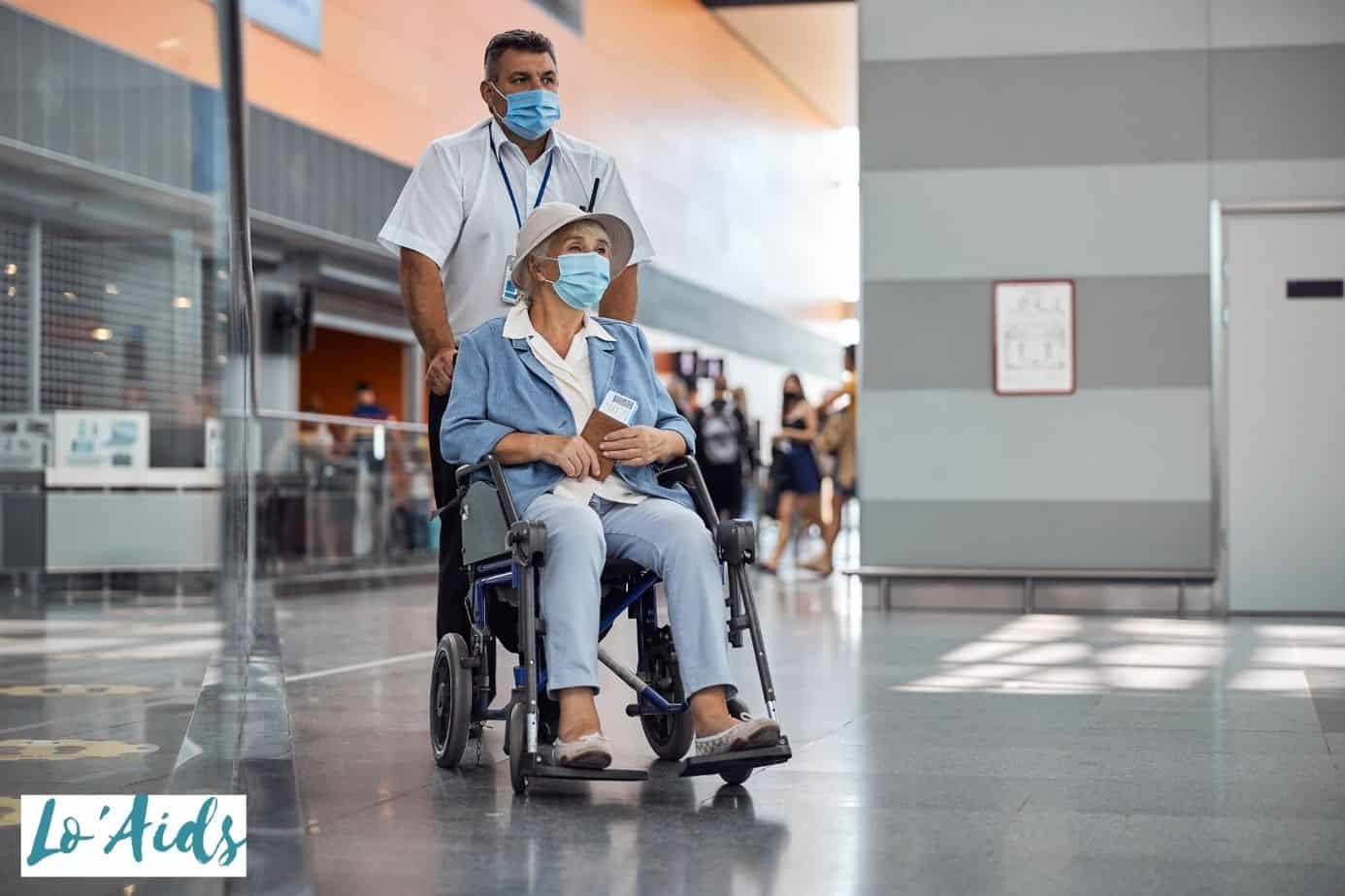 hospital staff pushing a senior in a transport wheelchair