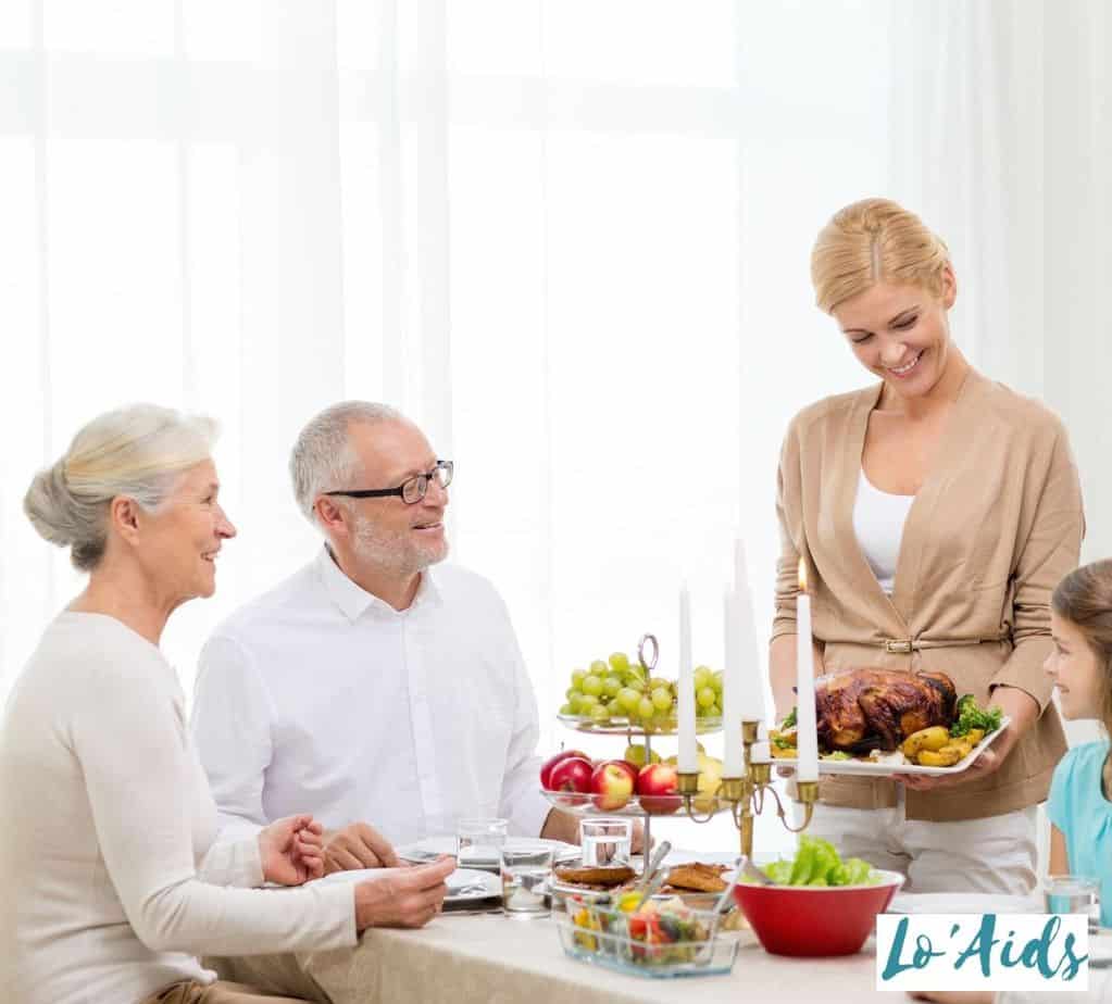 a joyful family having a family dinner for 75th birthday ideas of their father