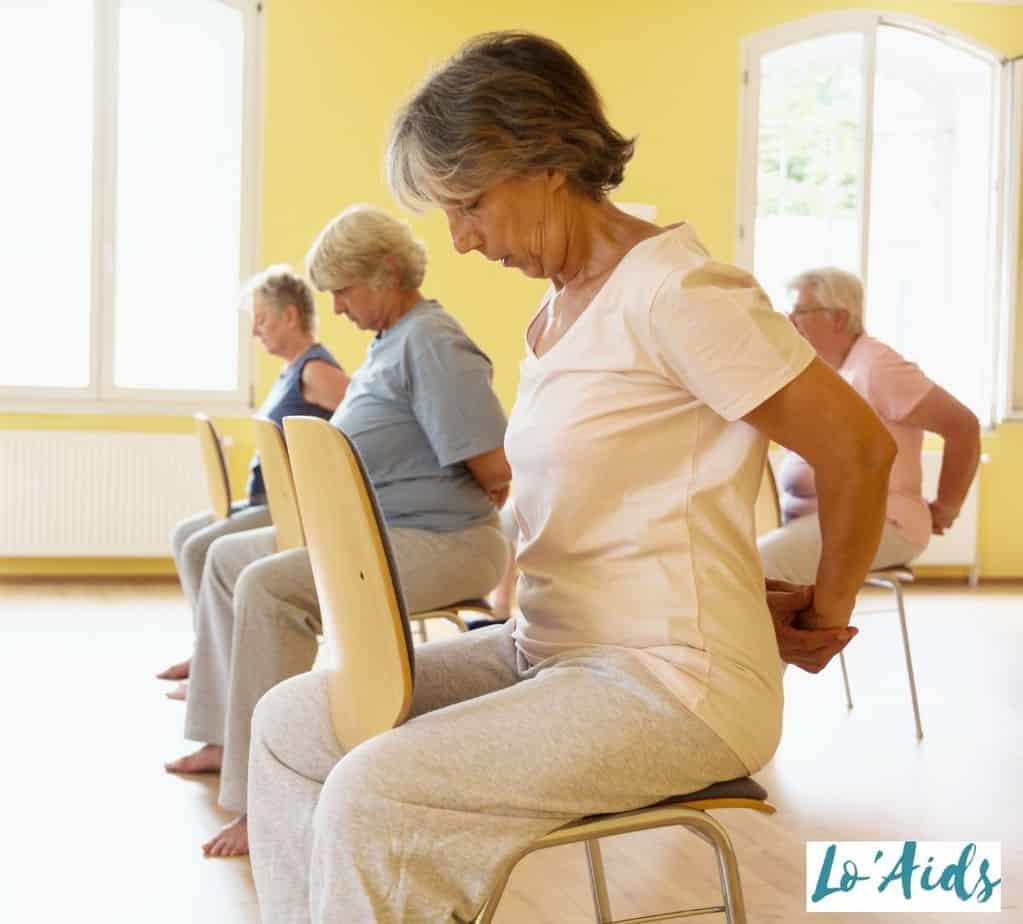 senior women doing chair seated yoga