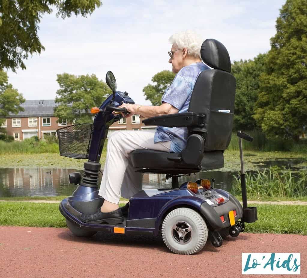 a side view of an elderly woman riding a mobility scooter