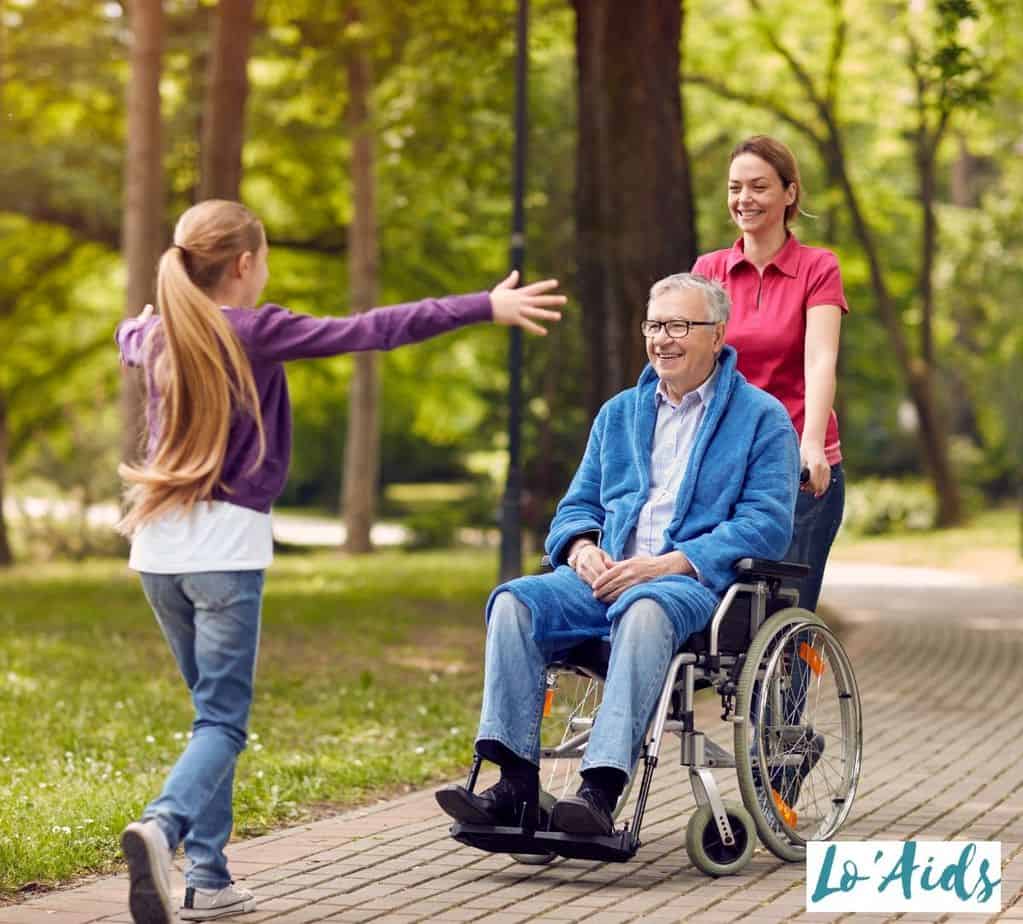 little girl about to embrace her grandpa in wheelchair