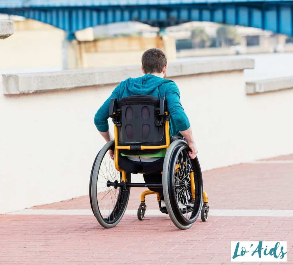 back view of a man propelling his wheelchair