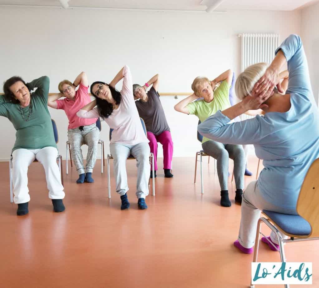 women having chair seated yoga exercises