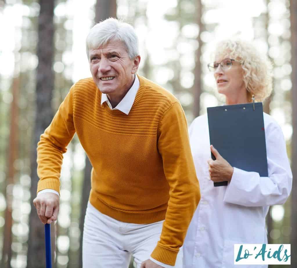 senior practicing to walk with his doctor