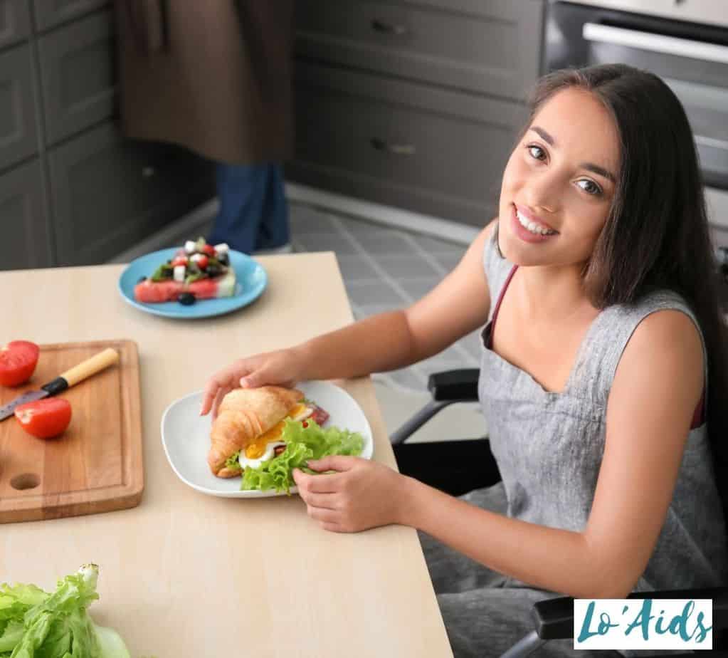 pretty girl in a wheelchair eating healthy breakfast