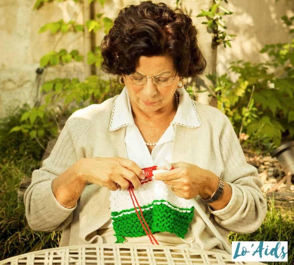 elderly woman knitting, one of the fun crafts for seniors with arthritis