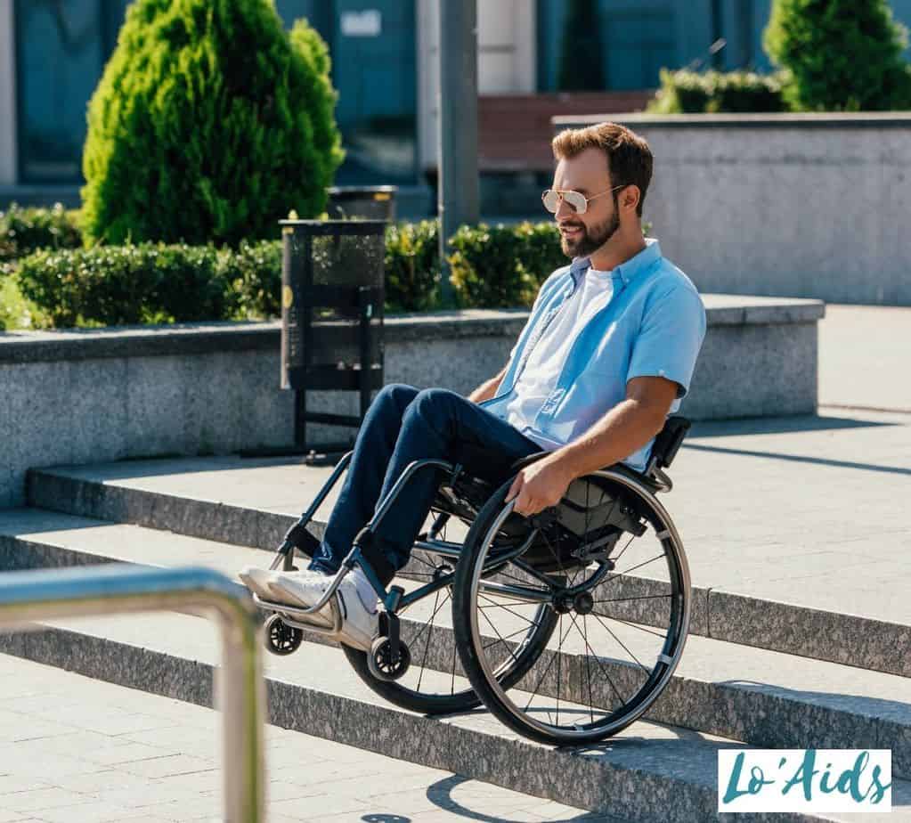 man propelling a wheelchair on the stairs