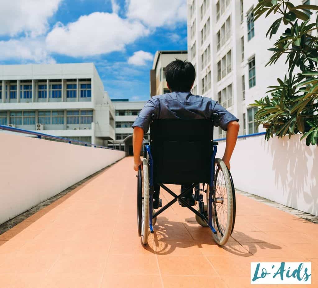 man showing how to push a wheelchair by himself