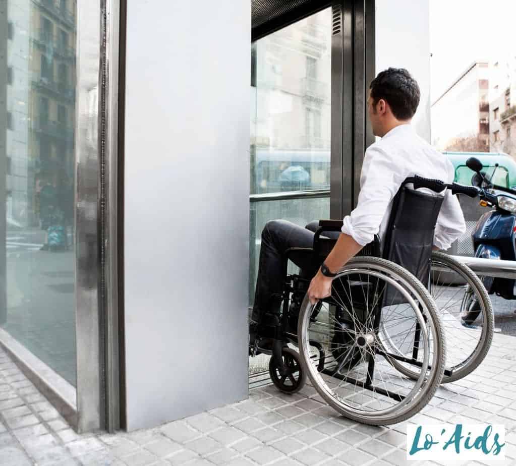 man in a wheelchair getting inside the elevator