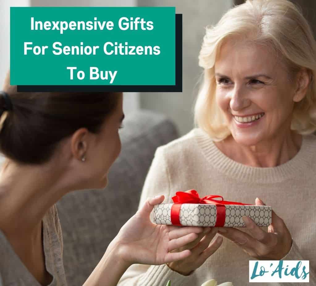A younger lady giving an elderly lady a small wrapped gift