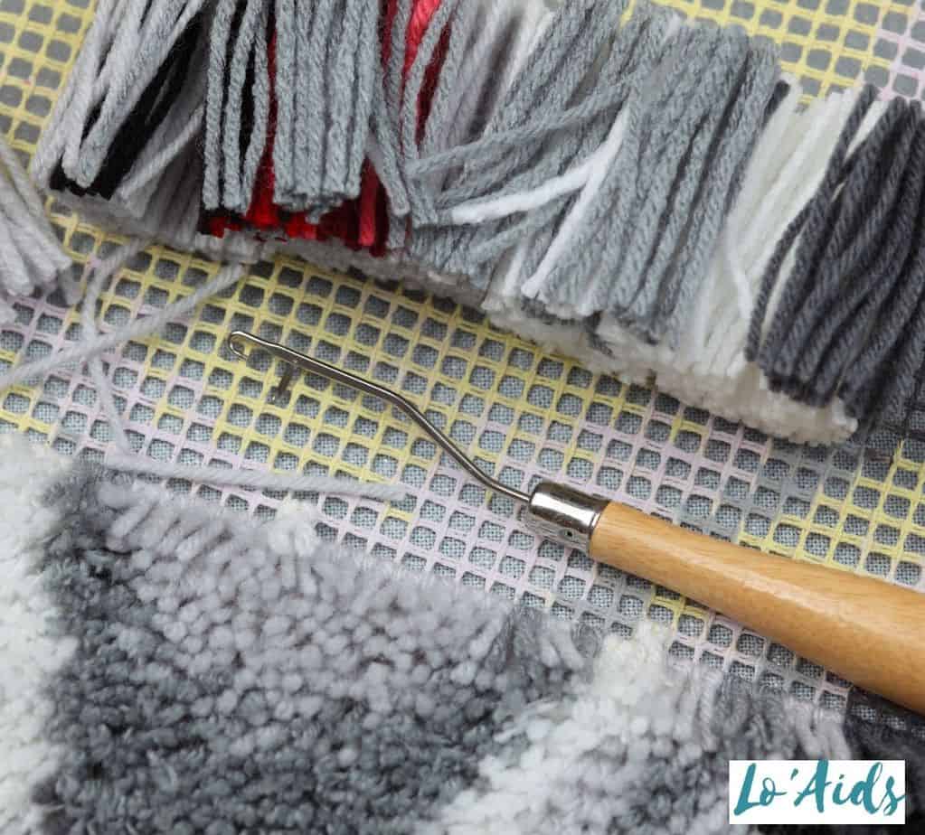 latch hook craft activity with white and grey yarn for seniors with Parkinson's disease