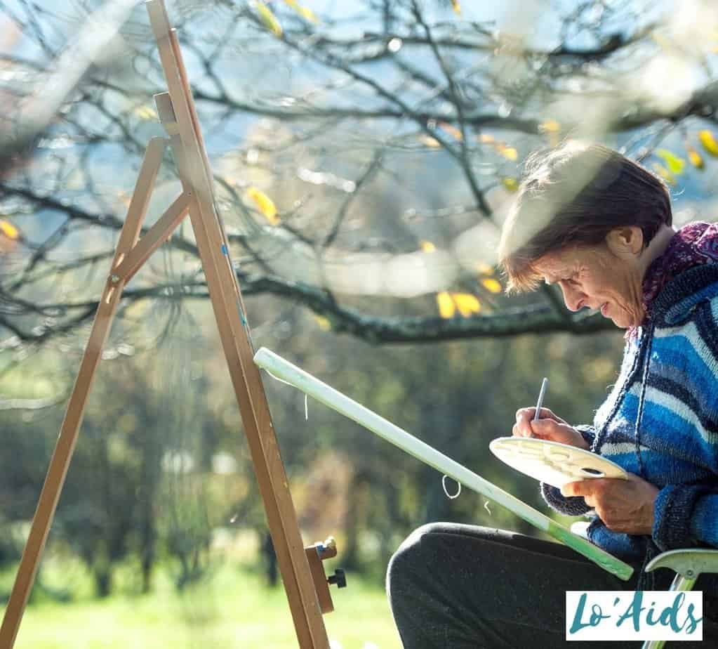 an elderly man painting