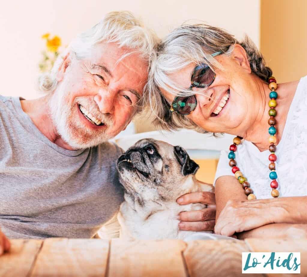 HAPPY SENIOR COUPLE WITH THEIR PUG