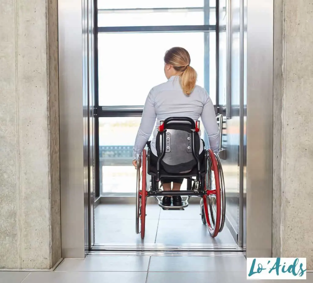 a women moving wheelchair in an elevator