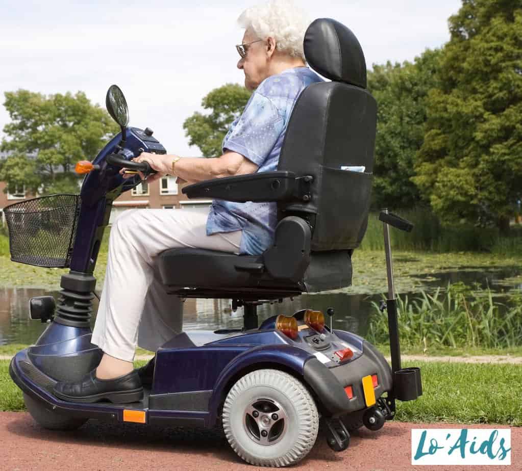 senior women riding large wheel mobility scooter