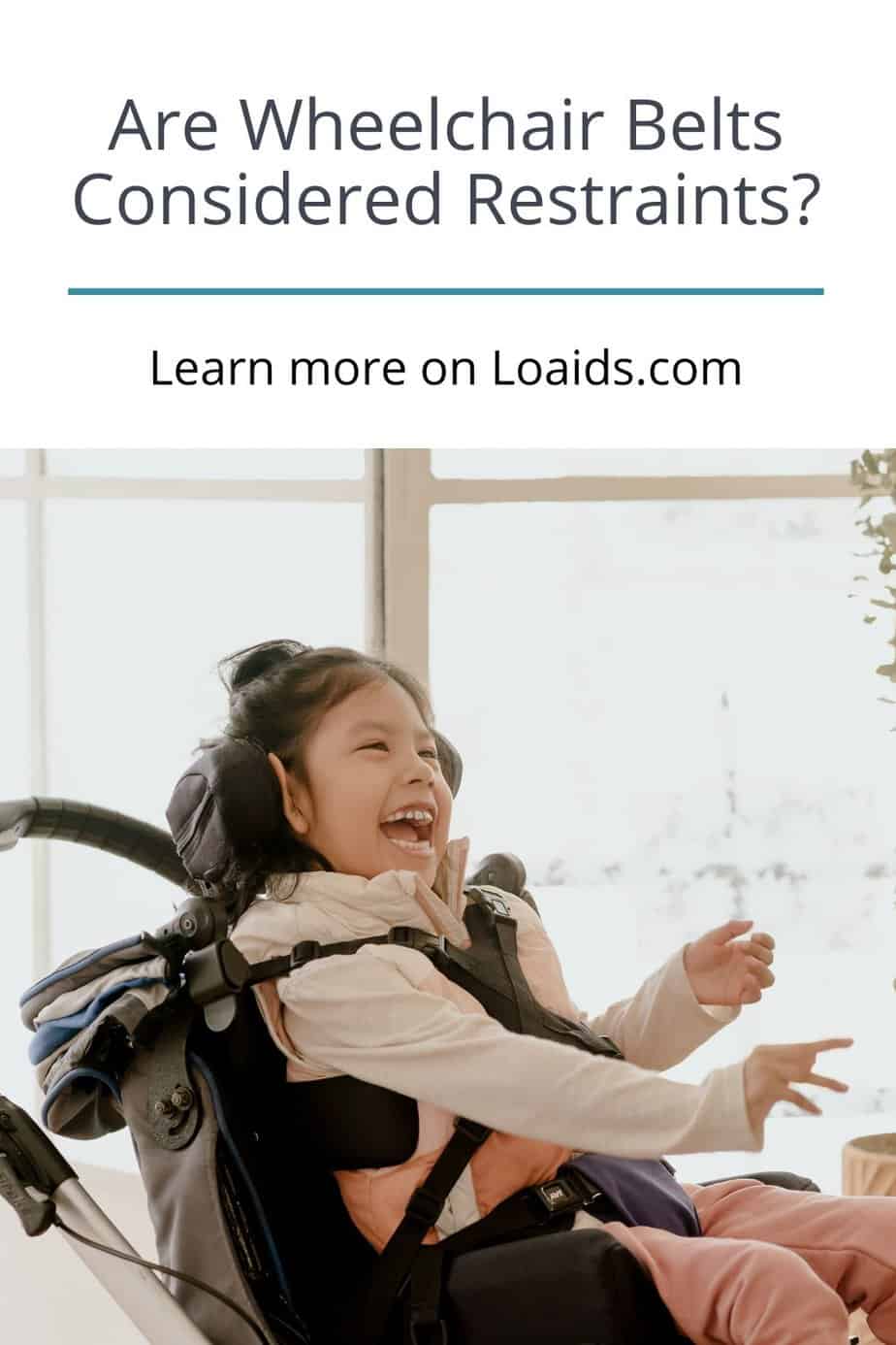 a kid sitting in a wheelchair while wearing a belt