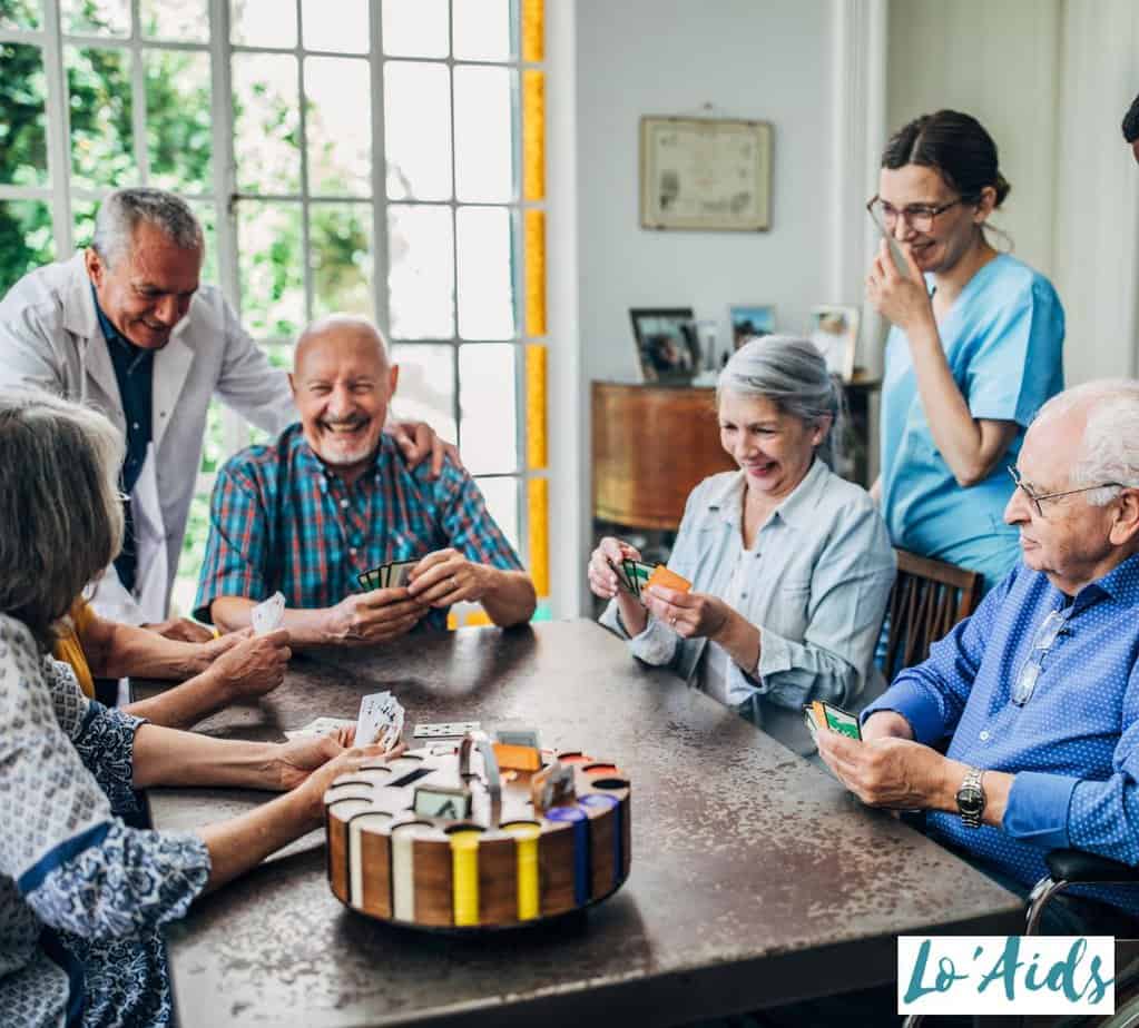 seniors playing card games with the doctor and nurse