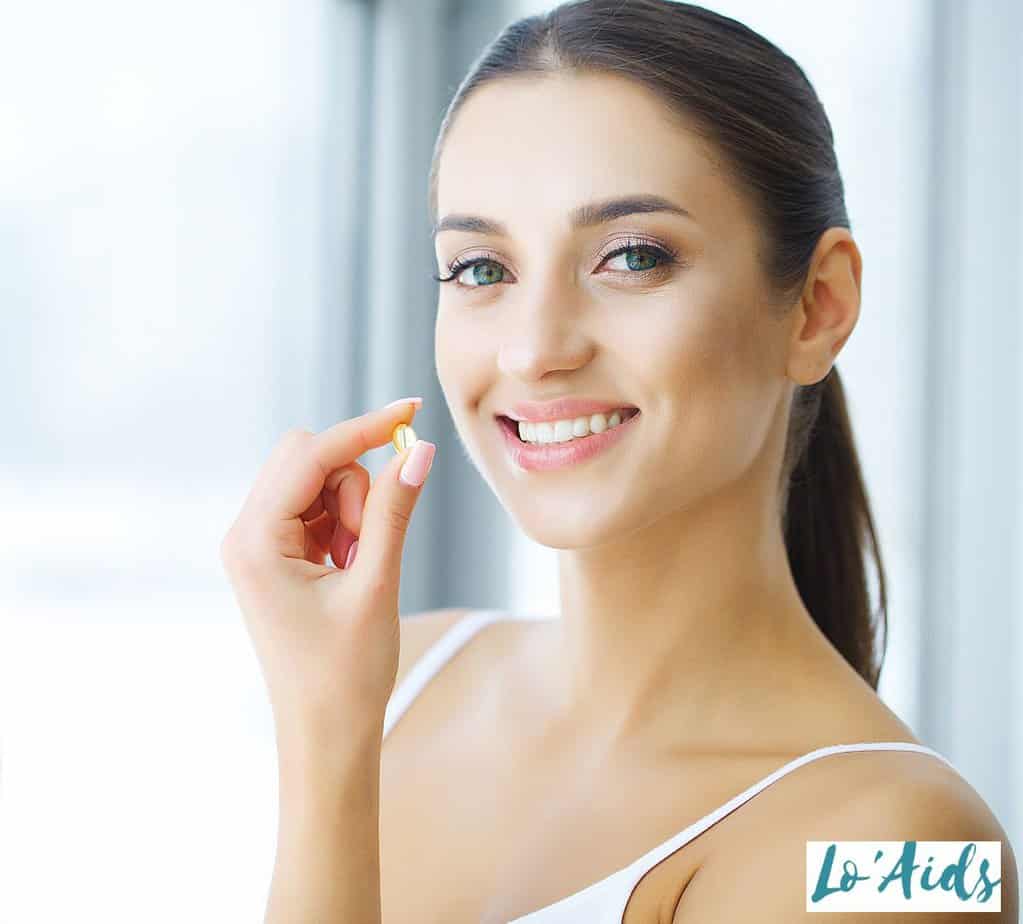 lady about to take an oral peptide supplement